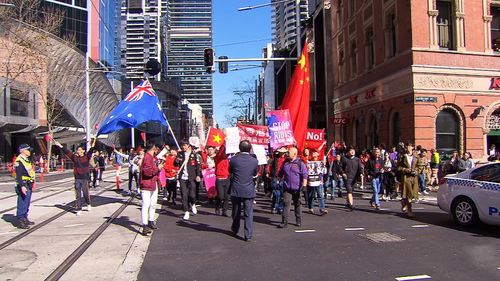 Activists have clashed with pro-China supporters in Sydney as thousands marched in Australia cities in response to ongoing protests in Hong Kong.