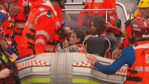 A family were rescued from floodwaters on the Hawkesbury River today twice, after an SES boat capsized.