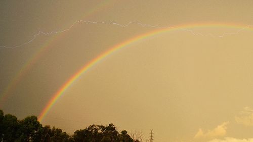 Lighting clashed with a double rainbow in Algester, Brisbane. (Dr Mahmood Nekooee)