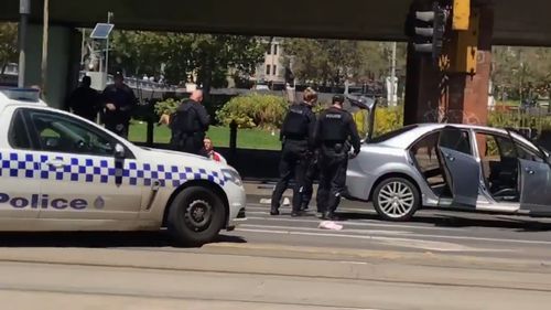 Heavily armed police have arrested a man in the Melbourne CBD.