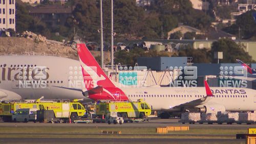A Qantas flight set for New Caledonia was unable to take off from Sydney after passengers reported flames shooting from the engine.