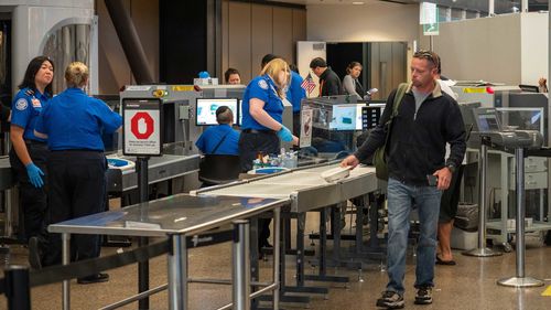 Man passes though Transportation Security Administration TSA security checkpoint at Seattle-Tacoma International Airport.