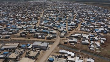 This April 19, 2020 file photo shows a large refugee camp on the Syrian side of the border with Turkey, near the town of Atma, in Idlib province, Syria.