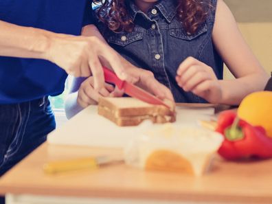 Mother and child cutting sandwich