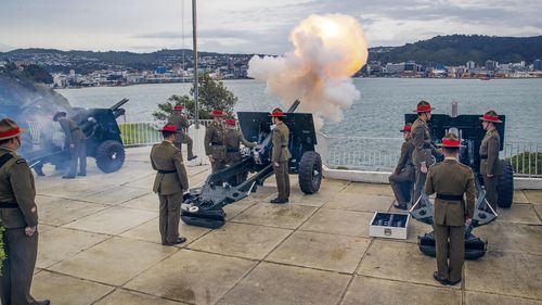 The Royal Regiment of New Zealand Artillery, using four 25-pounder guns, react during their 21-gun salute at Point Jerningham, to mark the 70th anniversary of the coronation of the Queen, Elizabeth II, in Wellington, New Zealand, Thursday, June 2, 2022. (Mark Mitchell/NZME via AP)