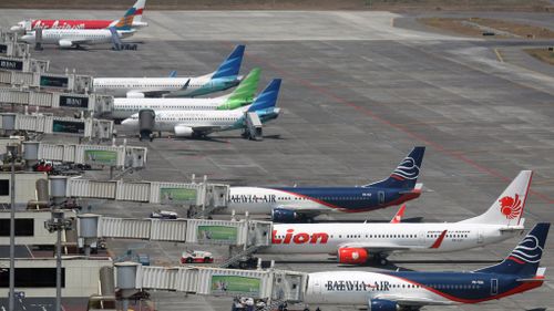 Planes line the tarmac at Juanda International Airport in Surabaya, Indonesia. (AAP)