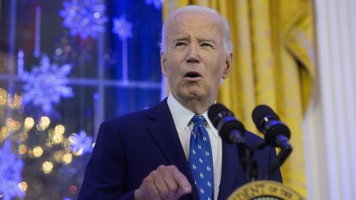  President Joe Biden speaks during a Hanukkah reception in the East Room of the White House in Washington.