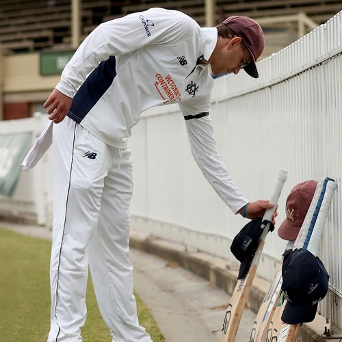 Todd Murphy, de Victoria, coloca seus bastões e boné em homenagem ao falecido Ben Austin durante um minuto de silêncio e homenagem no quarto dia da partida Sheffield Shield entre Victoria e Tasmânia no CitiPower Centre, em 31 de outubro de 2025, em Melbourne, Austrália. 
