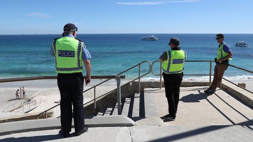 Police officers patrol Cottesloe Beach on April 10, 2020 in Perth, Australia.