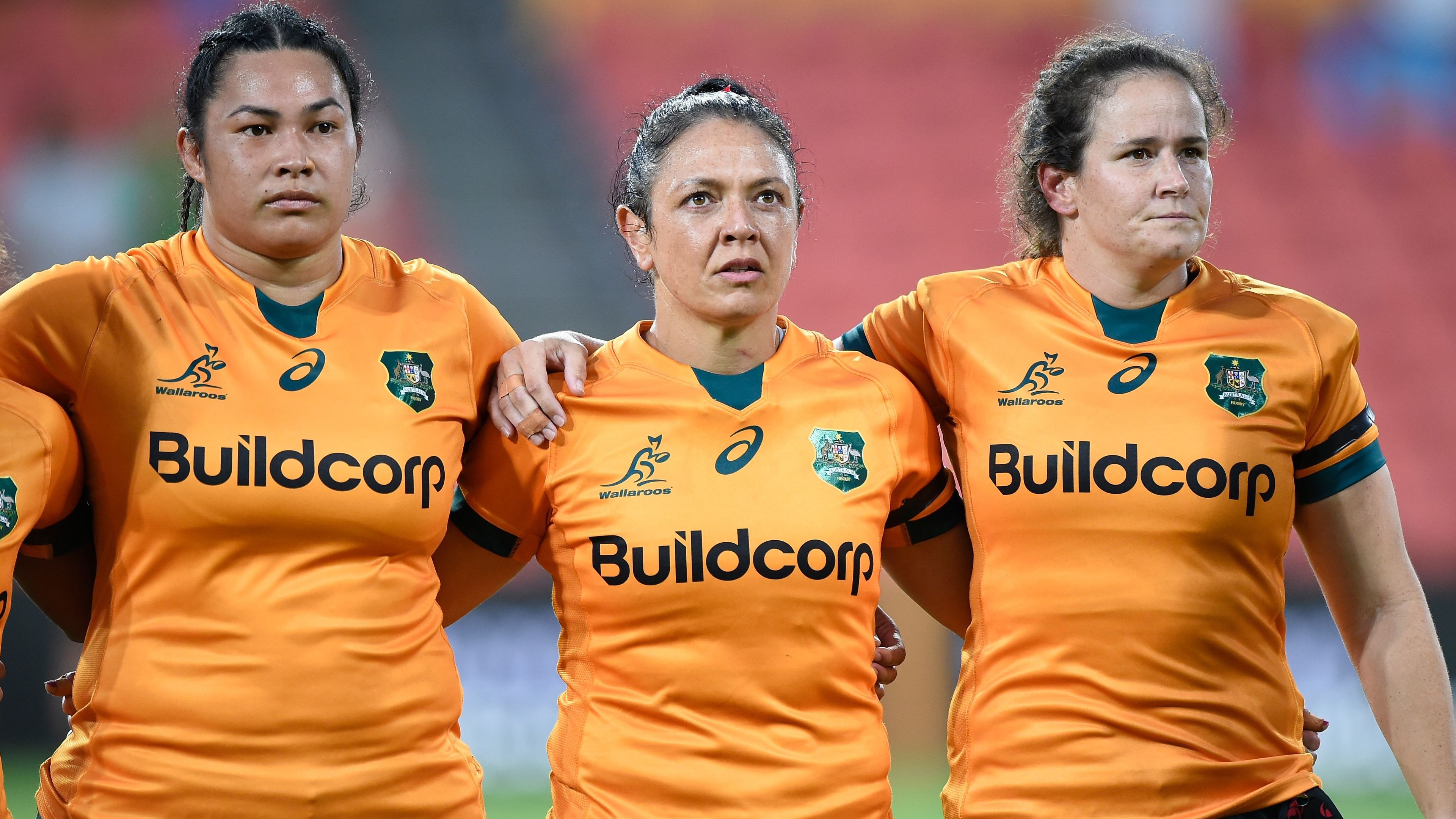Liz Patu (from left), Iliseva Batibasaga and Shannon Parry of the Wallaroos stand together during the national anthem.