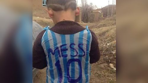 Twitter users unite to track down young soccer fan photographed wearing improvised plastic bag jersey