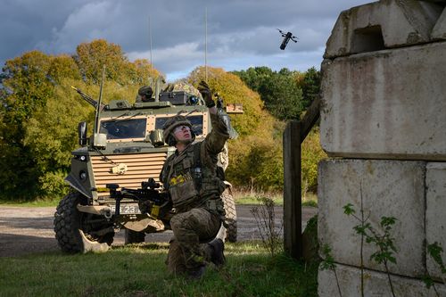 A British soldier launches a DefendTex D40 under-slung grenade launcher drone during a training exercise.