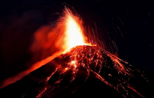 Red-hot rock and ash spewed into the sky and cascaded down the slopes of the Volcano of Fire.
