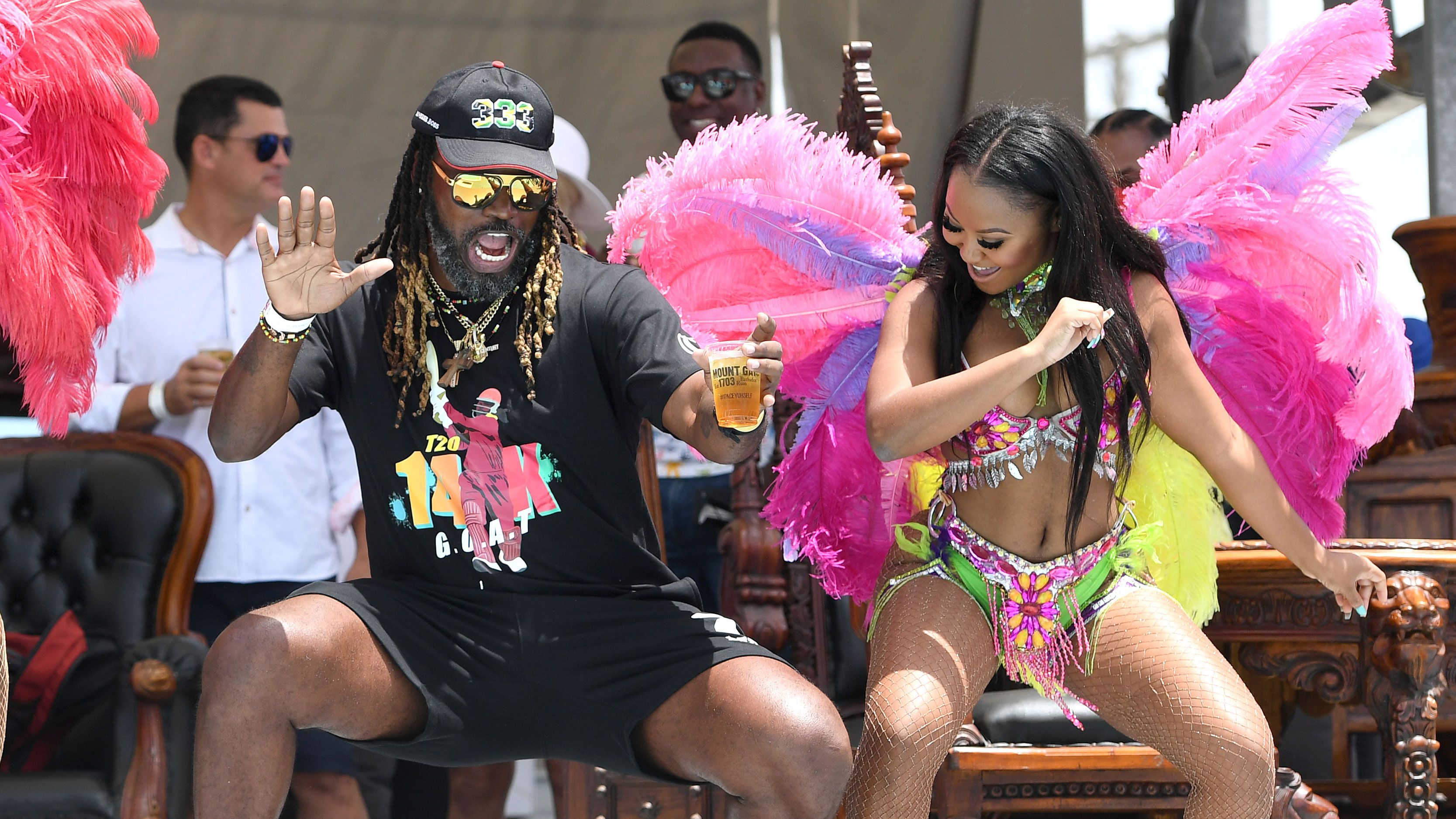 Former West Indies captain Chris Gayle gets jiggy with dancers on the party stand stage during a Test match between West Indies and England at Kensington Oval in march, 2022.