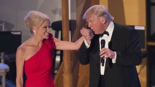 Donald Trump kisses the hand of former campaign manager, Kellyanne Conway, at the Candlelight Dinner at Union Station on the day before his inauguration.