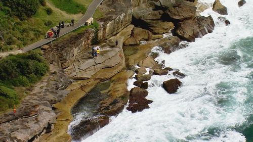 Man's body found washed up on rocks near freshwater.