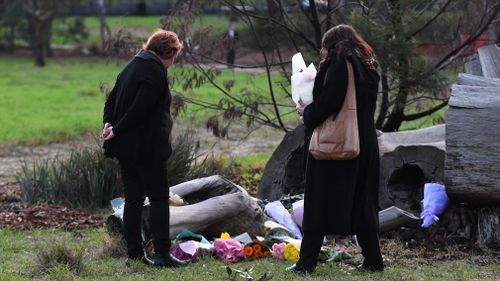 Mourners are seen at a makeshift memorial for Ms Herron.