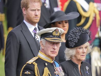 King Charles III, Camilla, the Queen Consort, Meghan, Duchess of Sussex, and Prince Harry watch as the coffin of Queen Elizabeth II is placed into the hearse following the state funeral service in Westminster Abbey in central London Monday Sept. 19, 2022. 