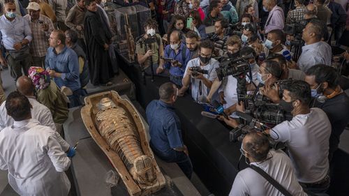 Egyptian antiquities officials on Saturday announced the discovery of at least 100 ancient coffins, some with mummies inside, and around 40 gilded statues south of Cairo.