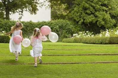 Children running outdoors at wedding
