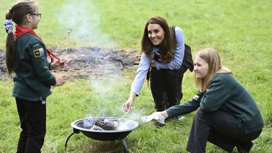 Kate, the Duchess of Cambridge toasts marshmallows with cubs during a visit to the 12th Northolt Scouts in West London, Tuesday September 29, 2020