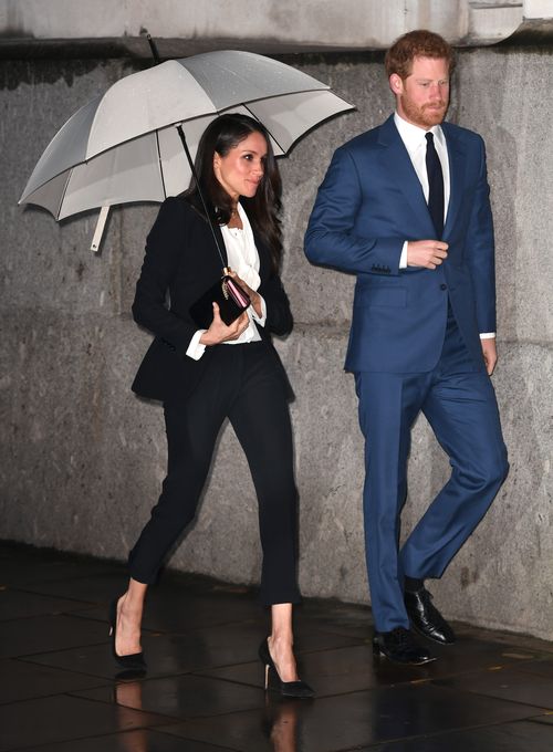 It was raining as the couple arrived at the event. Picture: AAP