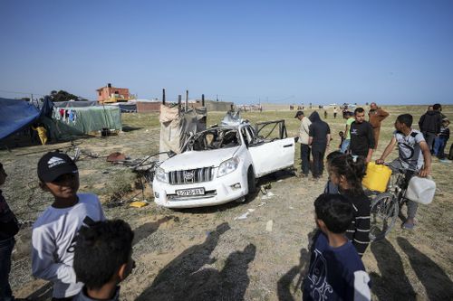 People inspect the site where World Central Kitchen workers were killed in Deir al-Balah, Gaza Strip, Tuesday, April 2, 2024.  