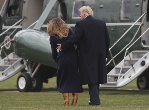 President Trump caught Melania as she tripped on her way to board the Marine One helicopter. (AAP)