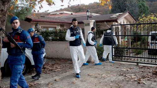 Officers collect evidence from a Turkish villa.