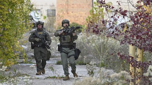 Officers with the Frederick County Sheriiff's Dept. SWAT Team search for suspect Pedro Argote.