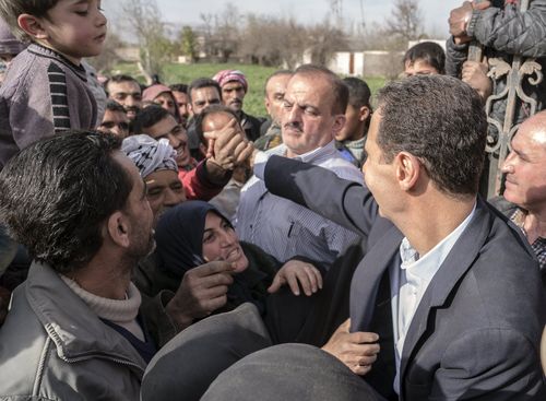 He was greeted by enthusiastic locals in the newly captured areas of eastern Ghouta. (AAP)