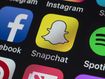 London, UK - July 19, 2018: The buttons of Instagram, Skype, Pinterest, Spotify, Snapchat Facebook and other apps on the screen of an iPhone.