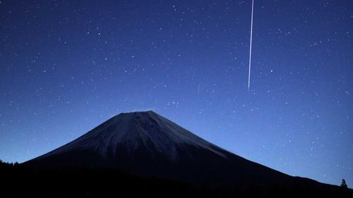 A meteor enters the Earth's atmosphere near Mount Fuji, Japan.