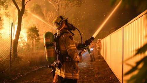 A firefighter in action in Wattle Grove. (AAP)