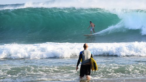 Up to 50 rescues were made at beaches on the Gold Coast and Sunshine Coast over the weekend of swimmers and surfers unable to cope with the strong swells (AAP).