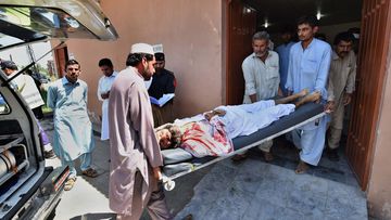 Pakistani volunteers transport an injured blast victim at a hospital following a suicide bomb attack at a district court in Mardan on September 2, 2016. (AFP)