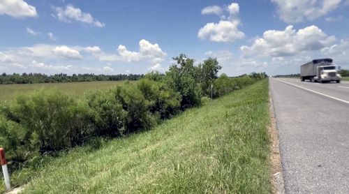 This image made from video provided by KPLC shows a truck passing along the highway where a 1-year-old child was found