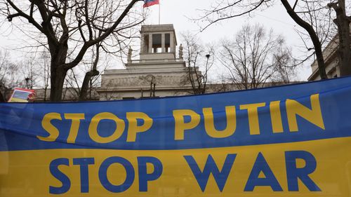 Protesters hold a banner reading stop Putin stop war in Berlin, Germany. 