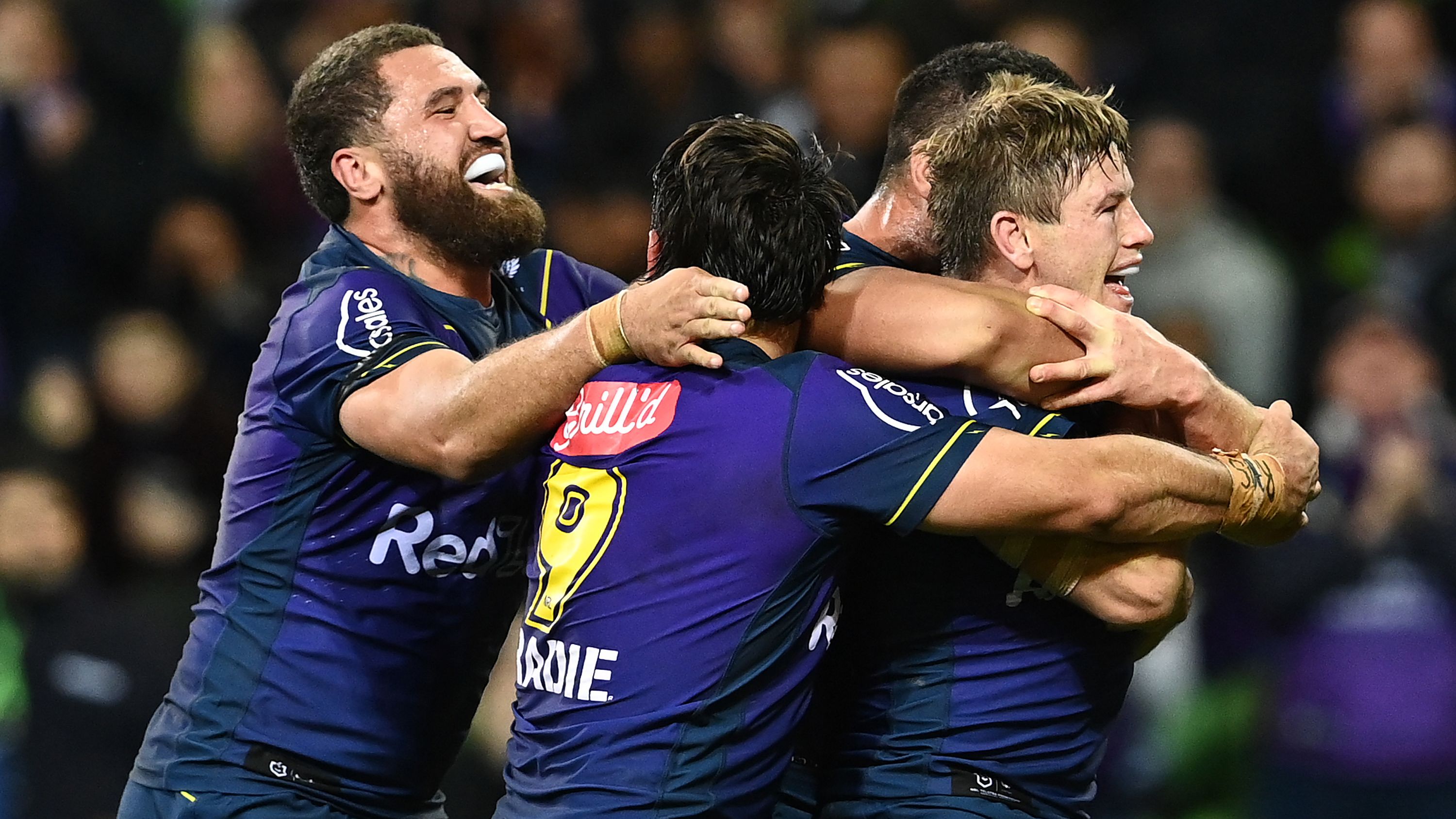 Harry Grant of the Storm celebrates with teammates after scoring a try.