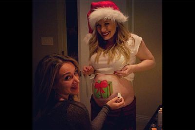 Who needs a blank canvas when you've got a big ol' belly to paint? Hilary Duff and sister, Haylie, got into the Christmas spirit with this creative body-painting snap.<br/><br/>Image: Twitter @hilaryduff