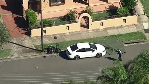 Aerial vision of the crash shows the bike lying next to a telegraph pole surrounded by debris, while the man lay several metres away. Picture: 9NEWS.