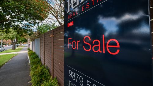 A for sale sign on a home.