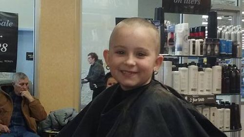 Eight-year-old girl shaves her head to support her cousin with cancer