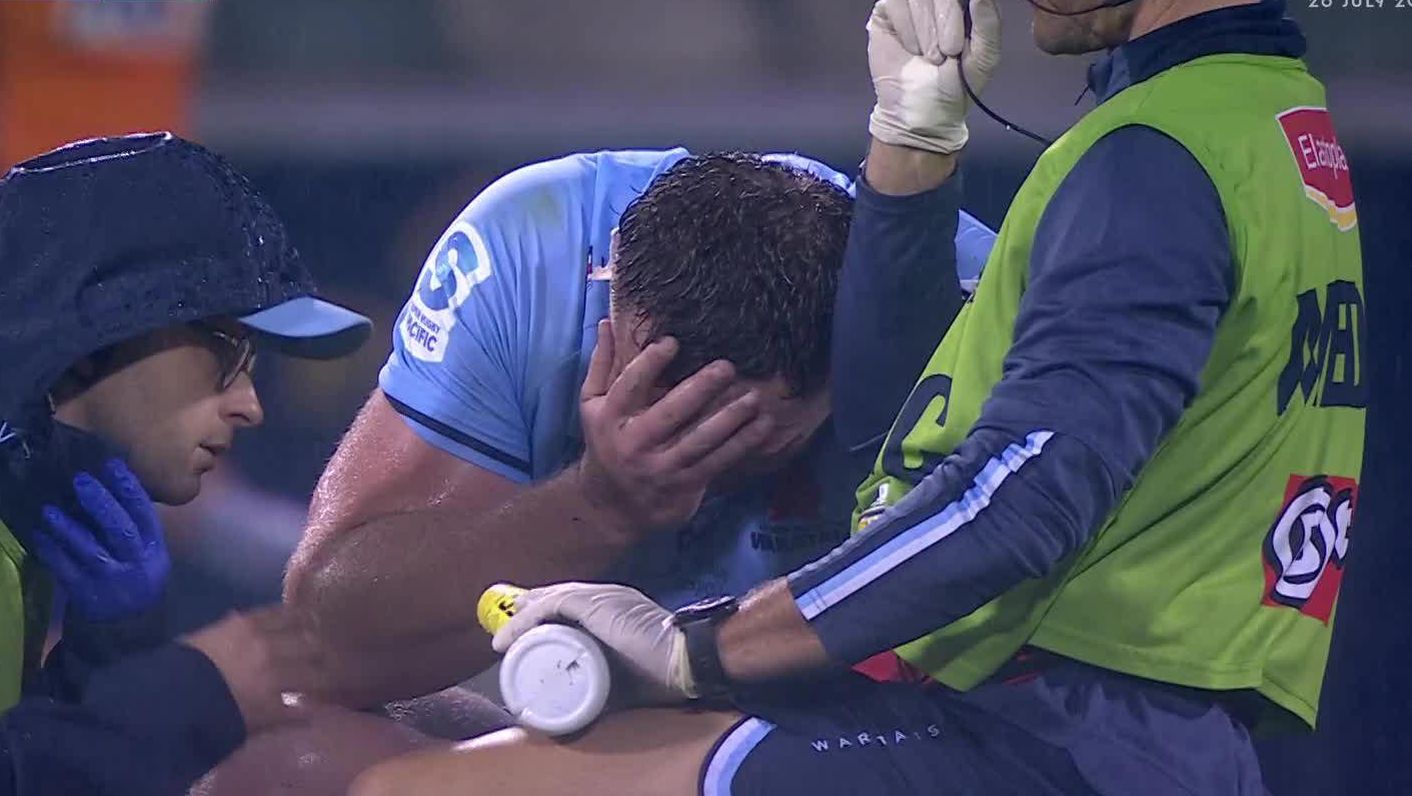 Angus Bell with head in hand after suffering a foot injury.