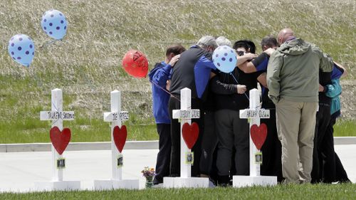 Families of the victims gather outside the Waffle House. (AP/AAP)