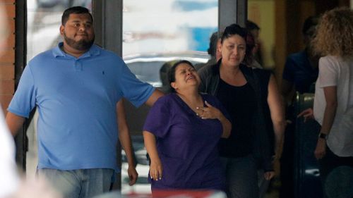 People react outside the unification centre at the Alamo Gym. Picture: AP