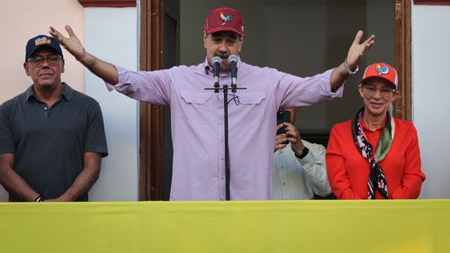 CARACAS, VENEZUELA - JULY 28: President NicolÃ¡s Maduro of Venezuela gestures as he speaks alongside First Lady Cilia Flores, and President of the National Assembly Jorge RodrÃ­guez to his supporters during the commemoration of the 71st Anniversary of the birth of late former President of Venezuela Hugo ChÃ¡vez on July 28, 2025 in Caracas, Venezuela. (Photo by Jesus Vargas/Getty Images)