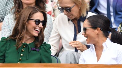  Catherine, Duchess of Cambridge and Meghan, Duchess of Sussex in the Royal Box on Centre Court during day twelve of the Wimbledon Tennis Championships at All England Lawn Tennis and Croquet Club on July 13, 2019 in London, England
