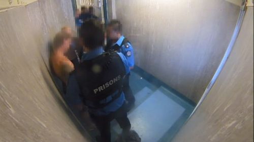 One of the guards bashes the man's head against the cell wall with his forearm and elbow. Picture: 9NEWS