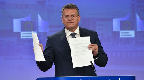 European Commissioner for Inter-institutional Relations and Foresight Maros Sefcovic holds up documents as he speaks during a media conference at EU headquarters in Brussels on Wednesday.